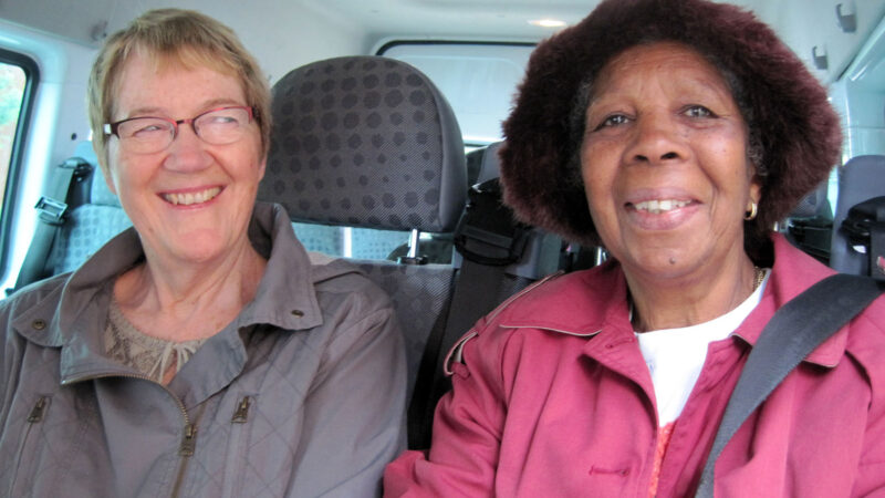 Two happy passengers on a bus